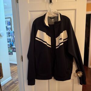 Nike size XL black track jacket with white accents in the chest. Long sl…